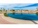 Scenic pond view featuring palm trees and beautiful home reflections under a partly cloudy sky at 7118 E Juanita Ave, Mesa, AZ 85209