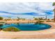 Scenic pond view with lush green shrubbery and palm trees under a partly cloudy sky at 7118 E Juanita Ave, Mesa, AZ 85209