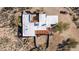 An aerial view of the property's modern roof design with several terraces, mature landscaping, and a tractor at 8115 E Paint Pony Dr, Carefree, AZ 85377