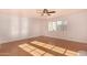 Sunlit bedroom with wood floors, ceiling fan, and large window showcasing natural light at 8115 E Paint Pony Dr, Carefree, AZ 85377