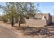 Charming side exterior view showcasing the desert home's stucco finish, desert landscaping and architectural details at 8115 E Paint Pony Dr, Carefree, AZ 85377