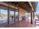 Covered patio featuring tile flooring, brick accents, and views of the surrounding desert landscape at 8115 E Paint Pony Dr, Carefree, AZ 85377