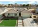 Stunning aerial view of this single-story home with tile roof, artificial turf, and block wall fence for added privacy at 815 E Tucci St, San Tan Valley, AZ 85140