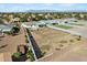 Aerial view of a property with a large vacant lot surrounded by residential homes at 815 E Tucci St, San Tan Valley, AZ 85140