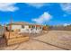 Sprawling backyard has plenty of space for Gathering and pets, with a firepit, seating, and play structures at 815 E Tucci St, San Tan Valley, AZ 85140