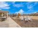 Large backyard features plenty of seating around a backyard firepit and multiple play structures at 815 E Tucci St, San Tan Valley, AZ 85140