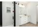 Contemporary bathroom featuring a walk-in shower with white tiled walls and a sleek black framed shower door at 815 E Tucci St, San Tan Valley, AZ 85140