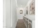 Bright hallway featuring wood floors and a decorative cabinet at 815 E Tucci St, San Tan Valley, AZ 85140