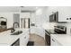 Bright kitchen featuring white cabinetry, stainless steel appliances, and a center island with a black faucet at 815 E Tucci St, San Tan Valley, AZ 85140