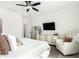 Inviting main bedroom featuring a ceiling fan, dresser, large mirror, and a comfortable sitting area at 815 E Tucci St, San Tan Valley, AZ 85140