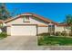 Charming single-Gathering home featuring a two-car garage and well-maintained front yard under a clear blue sky at 8812 E Riviera Dr, Scottsdale, AZ 85260