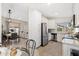 Bright kitchen with white cabinets, stainless steel appliances, and a view into the living room at 8812 E Riviera Dr, Scottsdale, AZ 85260