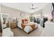 Well-lit primary bedroom features a ceiling fan, neutral walls, and a sliding glass door to the backyard at 8812 E Riviera Dr, Scottsdale, AZ 85260