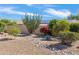 Backyard featuring desert landscaping, rock drainage, and mature trees at 9039 W Wescott Dr, Peoria, AZ 85382