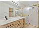 Bright bathroom featuring a vanity, modern lighting, and a separate glass enclosed shower at 9039 W Wescott Dr, Peoria, AZ 85382