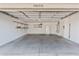 Spacious garage with shelving, storage, refrigerator, water heater, and access door at 9039 W Wescott Dr, Peoria, AZ 85382