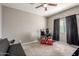 Minimalist bedroom with carpet, dark curtains, ceiling fan, and gaming setup on a desk at 9450 W Georgia Ave, Glendale, AZ 85305