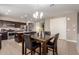 Open-concept dining area with chandelier and direct access to the kitchen featuring modern appliances at 9450 W Georgia Ave, Glendale, AZ 85305