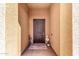 Inviting entryway with a dark wood door, neutral paint, and decorative floral arrangements at 9450 W Georgia Ave, Glendale, AZ 85305