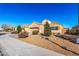 Attractive single-story home featuring a two-car garage, desert landscaping, and manicured front yard at 9450 W Georgia Ave, Glendale, AZ 85305