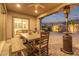 Cozy back patio with a dining area, patio heater, and string lights for evening relaxation at 9749 E Ripple Dr, Mesa, AZ 85212