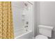 Bright bathroom with a shower-tub combination and a yellow-patterned shower curtain at 9749 E Ripple Dr, Mesa, AZ 85212