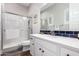 Bright bathroom featuring a glass-enclosed shower, modern vanity, and elegant gray and blue accents at 9749 E Ripple Dr, Mesa, AZ 85212