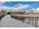 Scenic community walkway and water feature leading to an underpass beneath a bright sky at 9749 E Ripple Dr, Mesa, AZ 85212