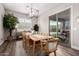 Bright dining room features a wood table, modern chandelier and sliding glass doors to the backyard at 9749 E Ripple Dr, Mesa, AZ 85212