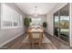 Dining room features a wood table, modern chandelier and sliding glass doors to the backyard at 9749 E Ripple Dr, Mesa, AZ 85212