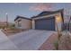 Attractive home featuring desert landscaping and a gray two-car garage, enhancing curb appeal at 9749 E Ripple Dr, Mesa, AZ 85212