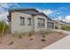 Landscaped front yard and gray exterior of this house gives it appealing curb appeal at 9749 E Ripple Dr, Mesa, AZ 85212