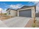 Attractive home featuring desert landscaping and a gray two-car garage, enhancing curb appeal at 9749 E Ripple Dr, Mesa, AZ 85212