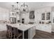 Spacious kitchen featuring white cabinetry, marble countertops, and modern pendant lighting at 9749 E Ripple Dr, Mesa, AZ 85212