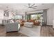 Open living room featuring a modern ceiling fan, wood floors, and an open concept design at 9749 E Ripple Dr, Mesa, AZ 85212