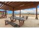 Community picnic tables with steel and wood construction under a shaded pavilion at 9749 E Ripple Dr, Mesa, AZ 85212