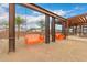 Community swings with heavy timber supports with orange bench seating at 9749 E Ripple Dr, Mesa, AZ 85212