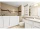 Bathroom featuring a walk-in tub, vanity, and tile flooring at 10103 W Saddle Ridge Dr, Sun City, AZ 85373