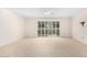 Spacious, carpeted bedroom featuring a ceiling fan and a sliding glass door to the patio at 10103 W Saddle Ridge Dr, Sun City, AZ 85373