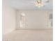 Neutral bedroom features carpet, a ceiling fan, and bright natural light at 10103 W Saddle Ridge Dr, Sun City, AZ 85373
