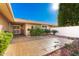 Private courtyard with tiled patio, mature landscaping, and a secure entry gate at 10103 W Saddle Ridge Dr, Sun City, AZ 85373