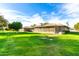 Spacious home features a large, lush green backyard and screened-in patio, perfect for outdoor living and entertaining at 10103 W Saddle Ridge Dr, Sun City, AZ 85373