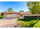 Charming single-story home with a brick facade, lush lawn, and a two-car garage at 10103 W Saddle Ridge Dr, Sun City, AZ 85373