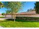 Charming single-story home with a brick facade, lush lawn, and a two-car garage at 10103 W Saddle Ridge Dr, Sun City, AZ 85373
