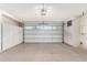 Spacious two-car garage with storage cabinets and a modern door at 10103 W Saddle Ridge Dr, Sun City, AZ 85373