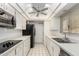 Functional kitchen featuring white cabinets, appliances, and bright lighting at 10103 W Saddle Ridge Dr, Sun City, AZ 85373
