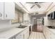 Efficient kitchen featuring white countertops, modern appliances, and bright lighting at 10103 W Saddle Ridge Dr, Sun City, AZ 85373