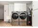 Laundry room with washer, dryer, sink, and cabinetry at 10103 W Saddle Ridge Dr, Sun City, AZ 85373