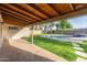 Spacious covered patio overlooks backyard with lush green lawn and refreshing pool at 1021 E Myrtle Ave, Phoenix, AZ 85020