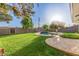 Landscaped backyard featuring a sparkling in-ground pool and lush green lawn at 1021 E Myrtle Ave, Phoenix, AZ 85020